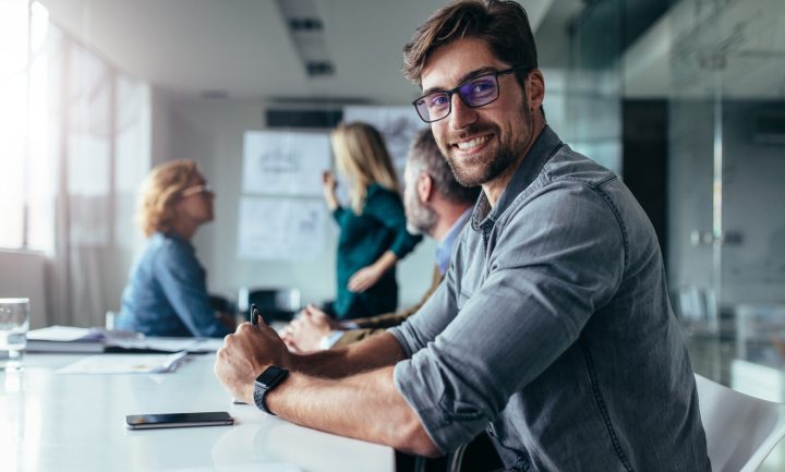 Man smiling during a meeting